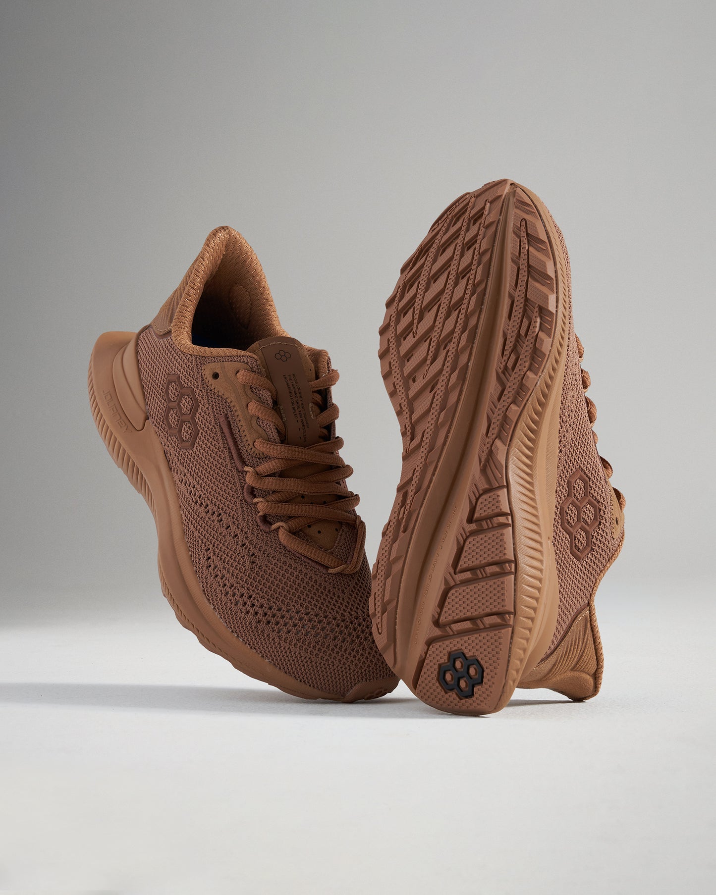 A pair of stylish brown running shoes featuring a breathable mesh upper and a textured sole designed for optimal grip and comfort