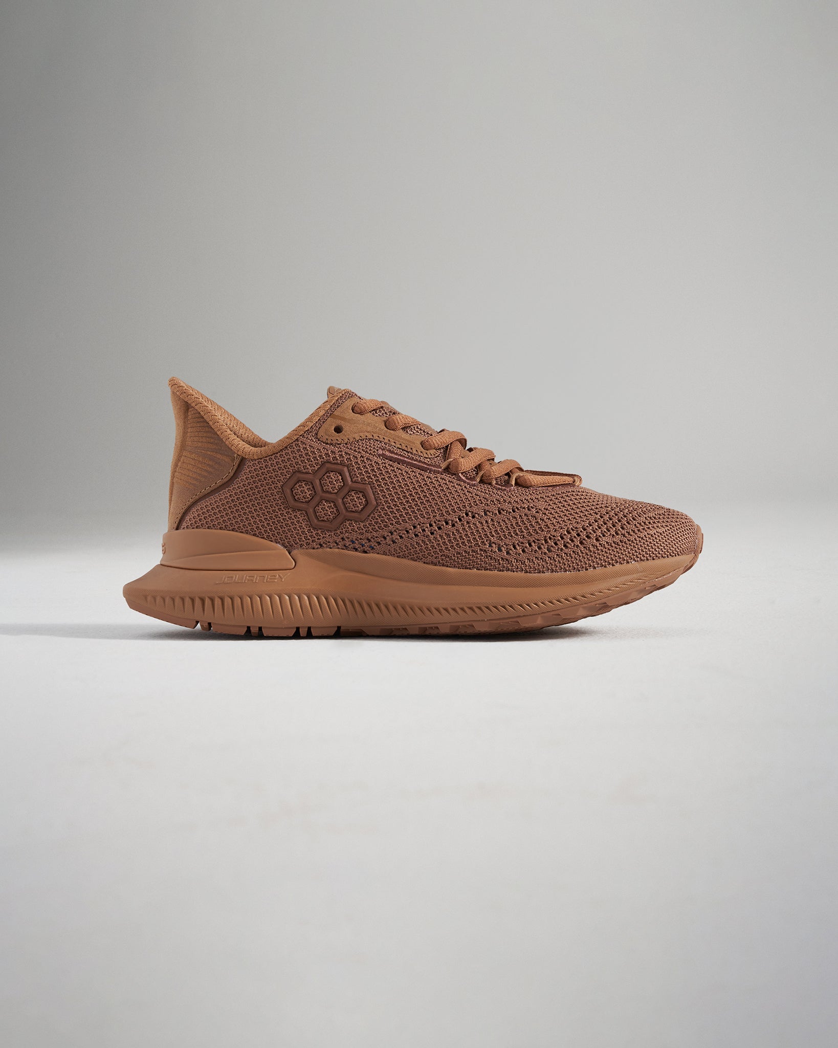 A brown athletic shoe featuring a breathable mesh upper and a supportive rubber sole designed for performance and comfort