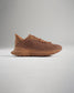 A brown athletic shoe featuring a breathable mesh upper and a supportive rubber sole designed for performance and comfort