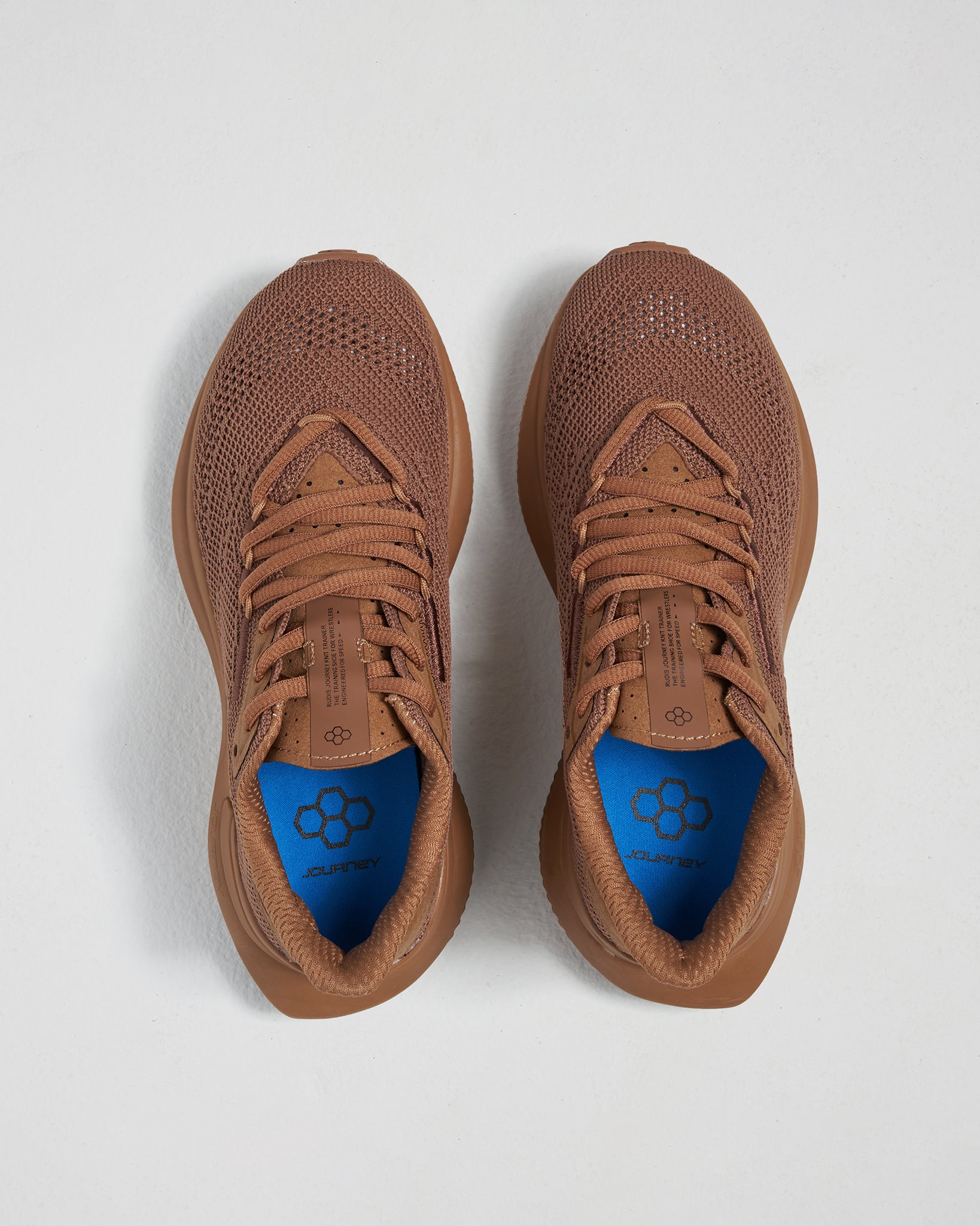 A pair of stylish brown athletic shoes with a breathable mesh upper featuring a blue insole with a honeycomb design and a lightweight sole suitable for running or casual wear