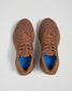 A pair of stylish brown athletic shoes with a breathable mesh upper featuring a blue insole with a honeycomb design and a lightweight sole suitable for running or casual wear