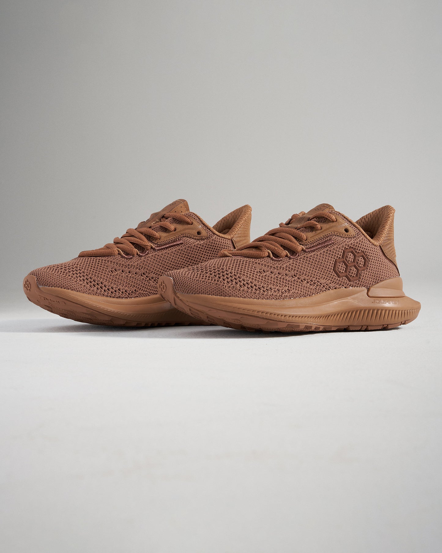 A pair of brown athletic shoes with a breathable mesh upper and durable sole designed for comfort and performance