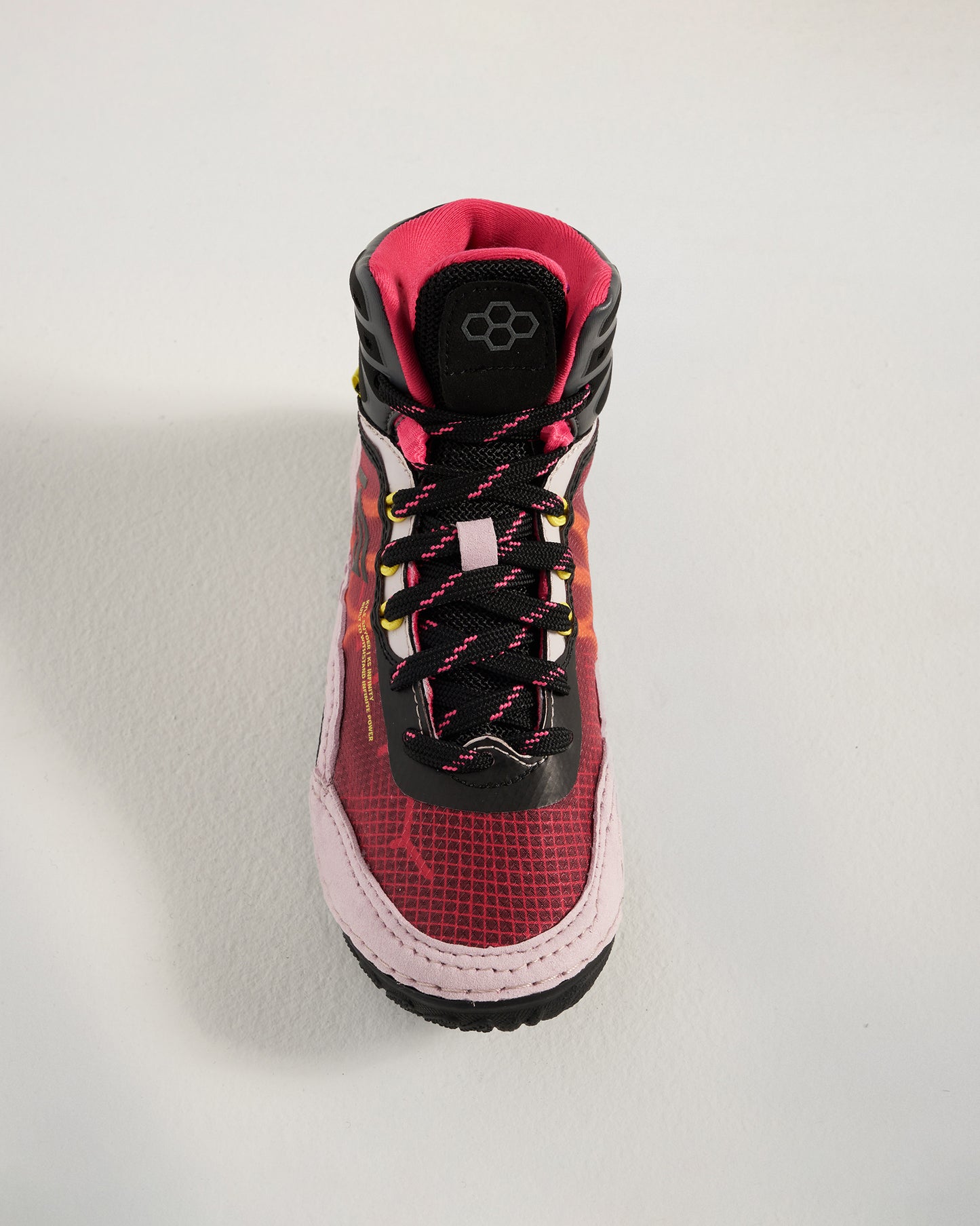A modern athletic shoe featuring a vibrant red and pink design with a high-top structure breathable mesh upper and durable rubber sole
