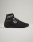 Black high-top athletic shoes designed for performance featuring a mesh upper and textured rubber sole for grip