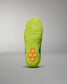 A detailed view of a vibrant green athletic shoe sole featuring a textured grip and a unique hexagonal pattern in bright orange