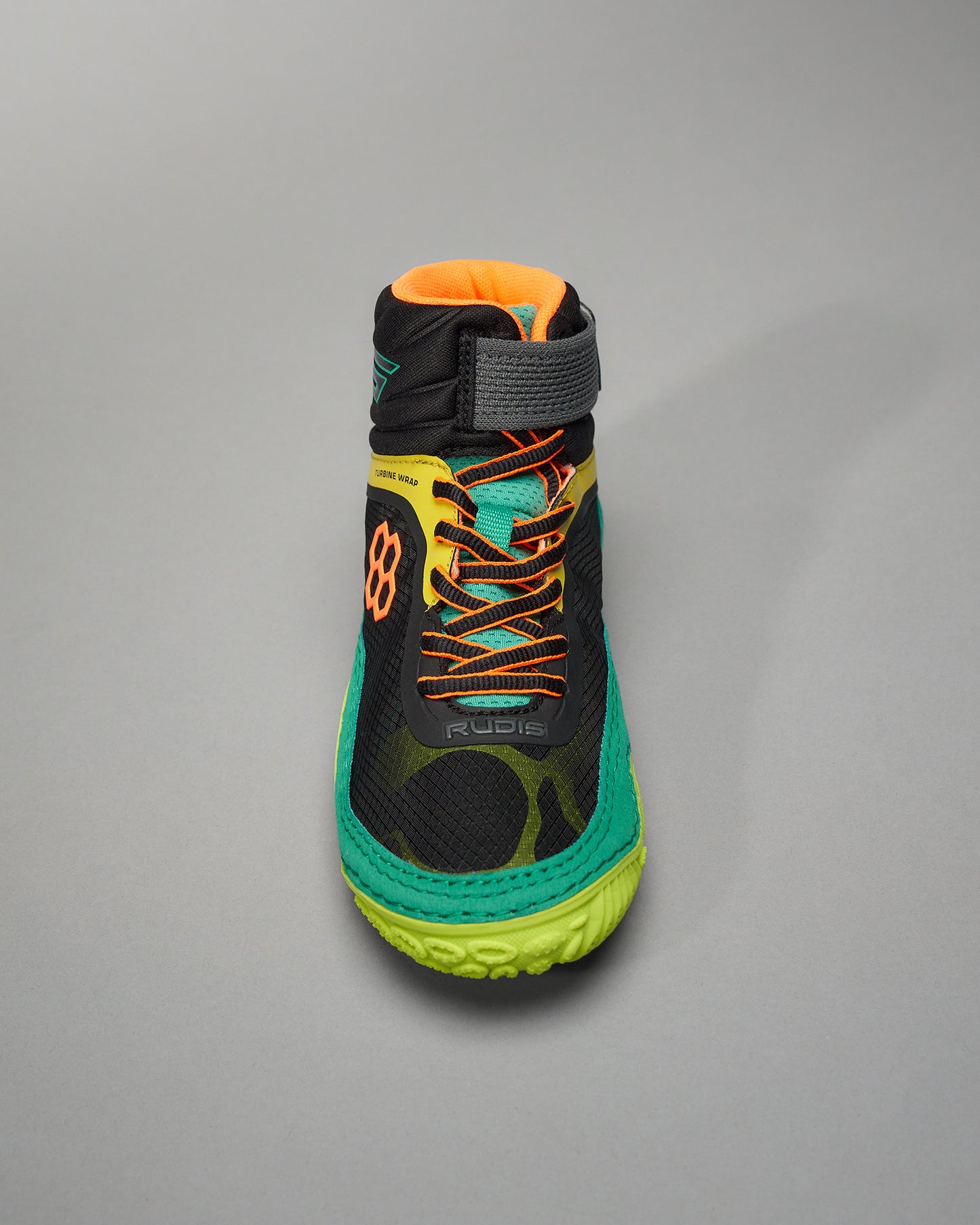 This image showcases a vibrant black athletic shoe featuring a high-top design bright orange accents and a striking green sole ideal for sports and active wear