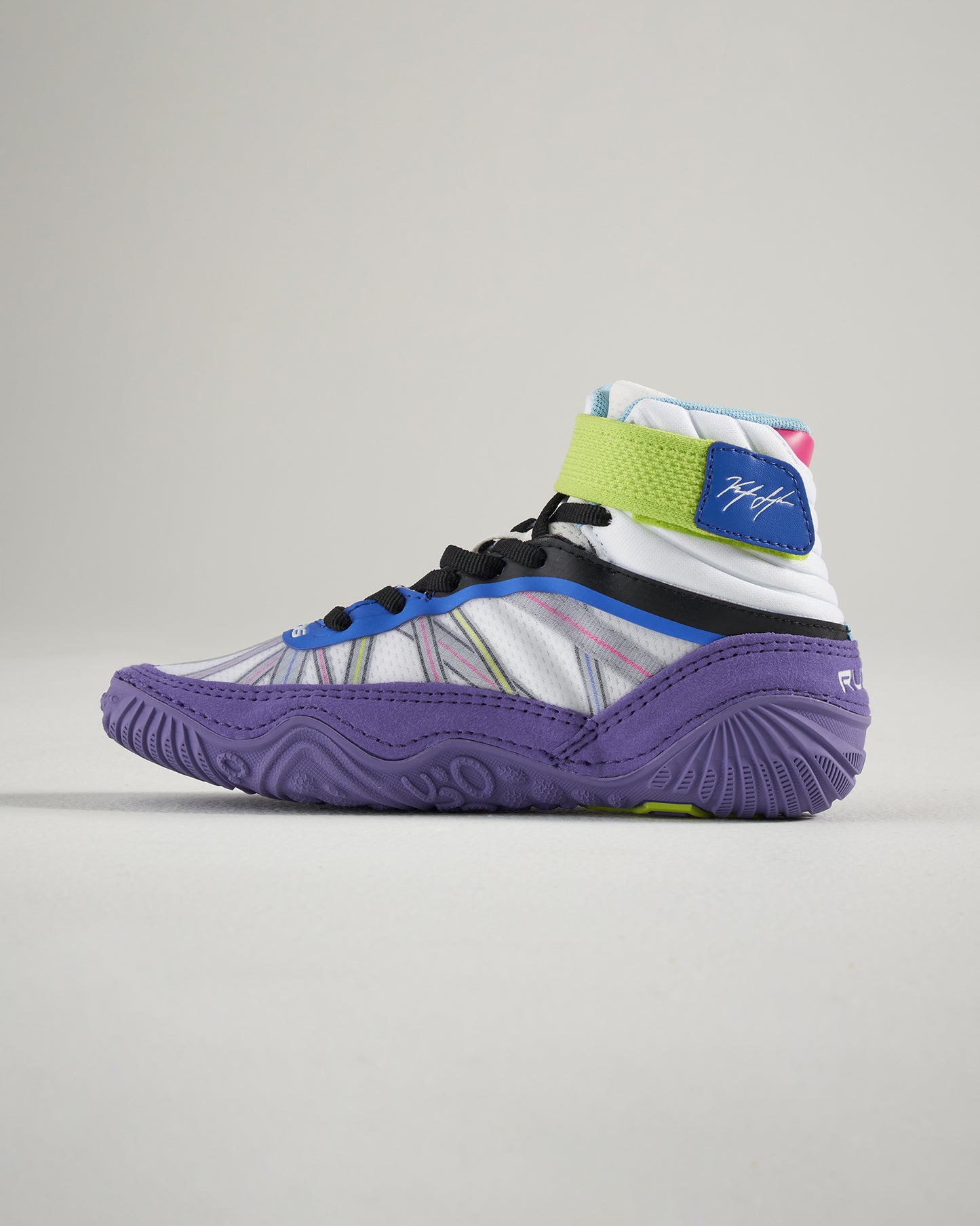 A modern high-top athletic shoe designed for performance featuring vibrant colors a unique pattern and a distinctive sole for traction