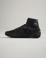 This image features a modern black athletic shoe with a high-top design showcasing a sleek silhouette textured upper and a flexible sole suitable for performance and style