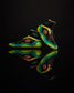 A pair of high-performance black basketball shoes with vibrant green and orange accents featuring a textured sole and unique design elements