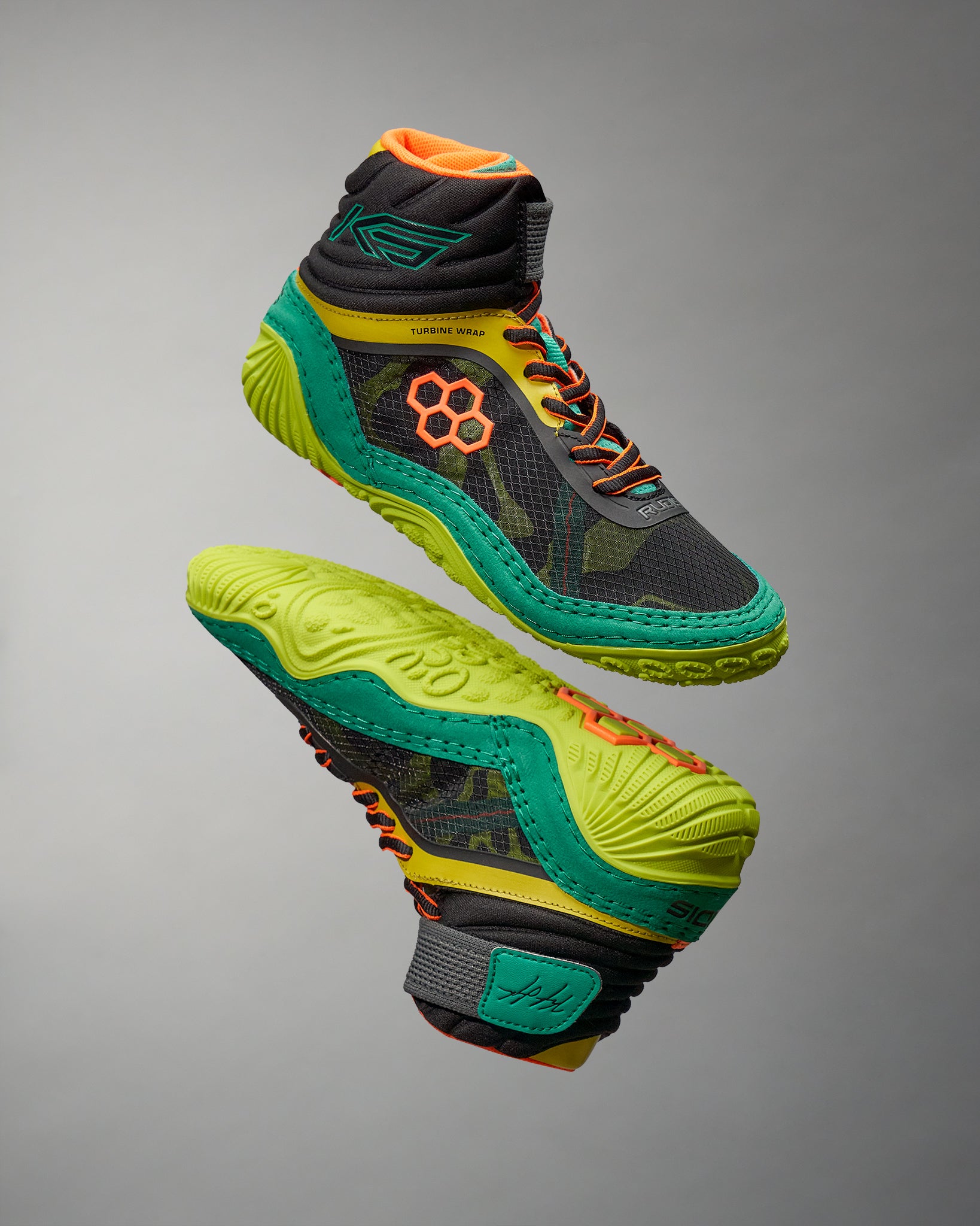 A dynamic pair of high-top athletic shoes featuring a blend of black green orange and yellow colors designed for performance and style