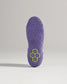 The image displays a detailed view of the sole of a purple athletic shoe featuring a unique tread pattern and a striking hexagonal logo in green