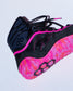 A wrestling shoe in black and vibrant neon pink, featuring a patterned pink and orange midsole, black laces, and a black protective ankle collar.