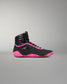 A high-top athletic wrestling shoe in black with vibrant neon pink accents on the collar, laces, and sole, shown from a side profile against a neutral gray background.