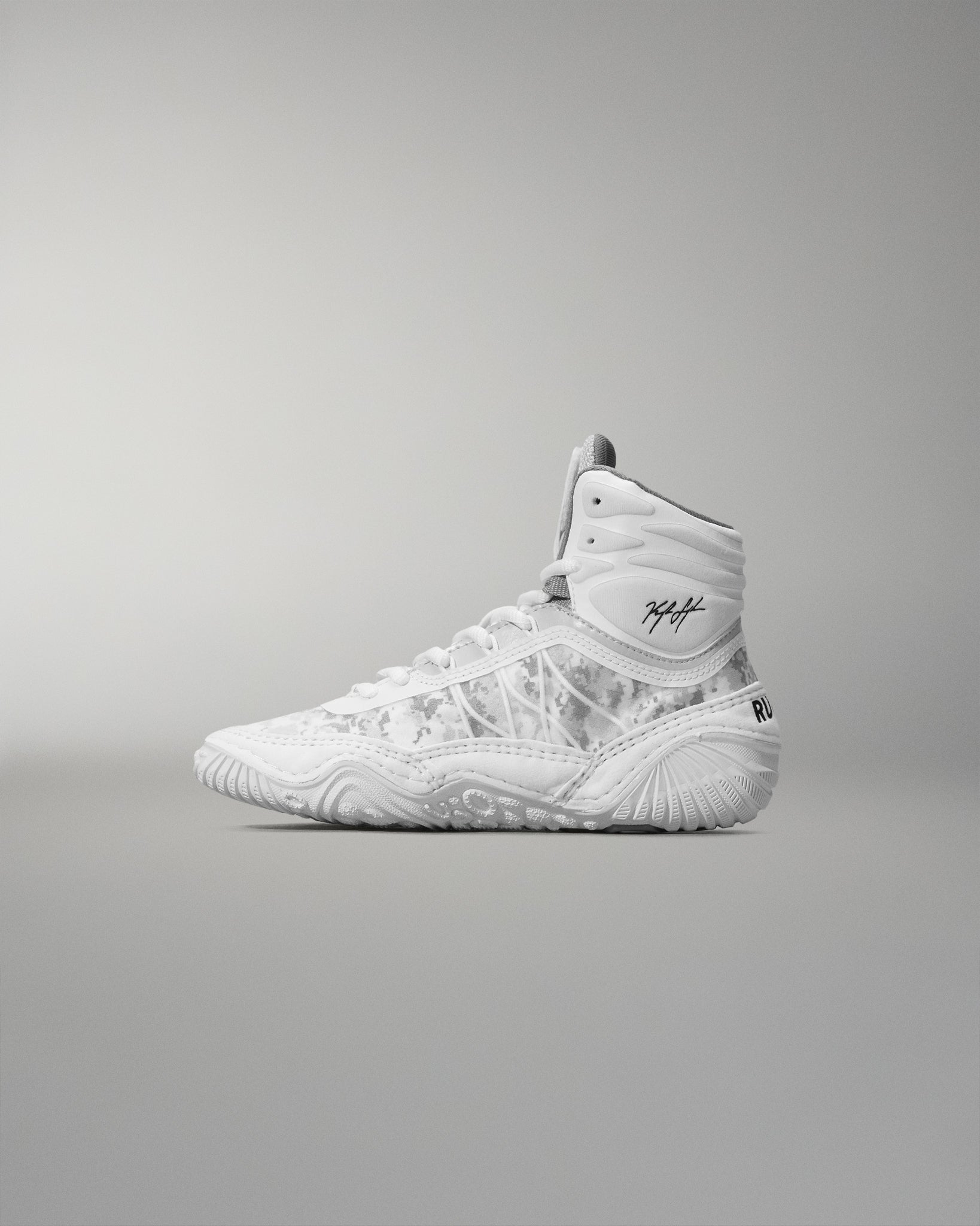 White high-top wrestling shoe on a gray background
