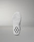 White wrestling shoe sole with a textured pattern and hexagonal logo on a gray background