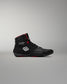 Black wrestling shoes with red accents on a gray background