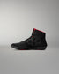 Black wrestling shoes with red accents on a gray background