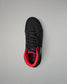 Black wrestling shoe with red interior on a gray background