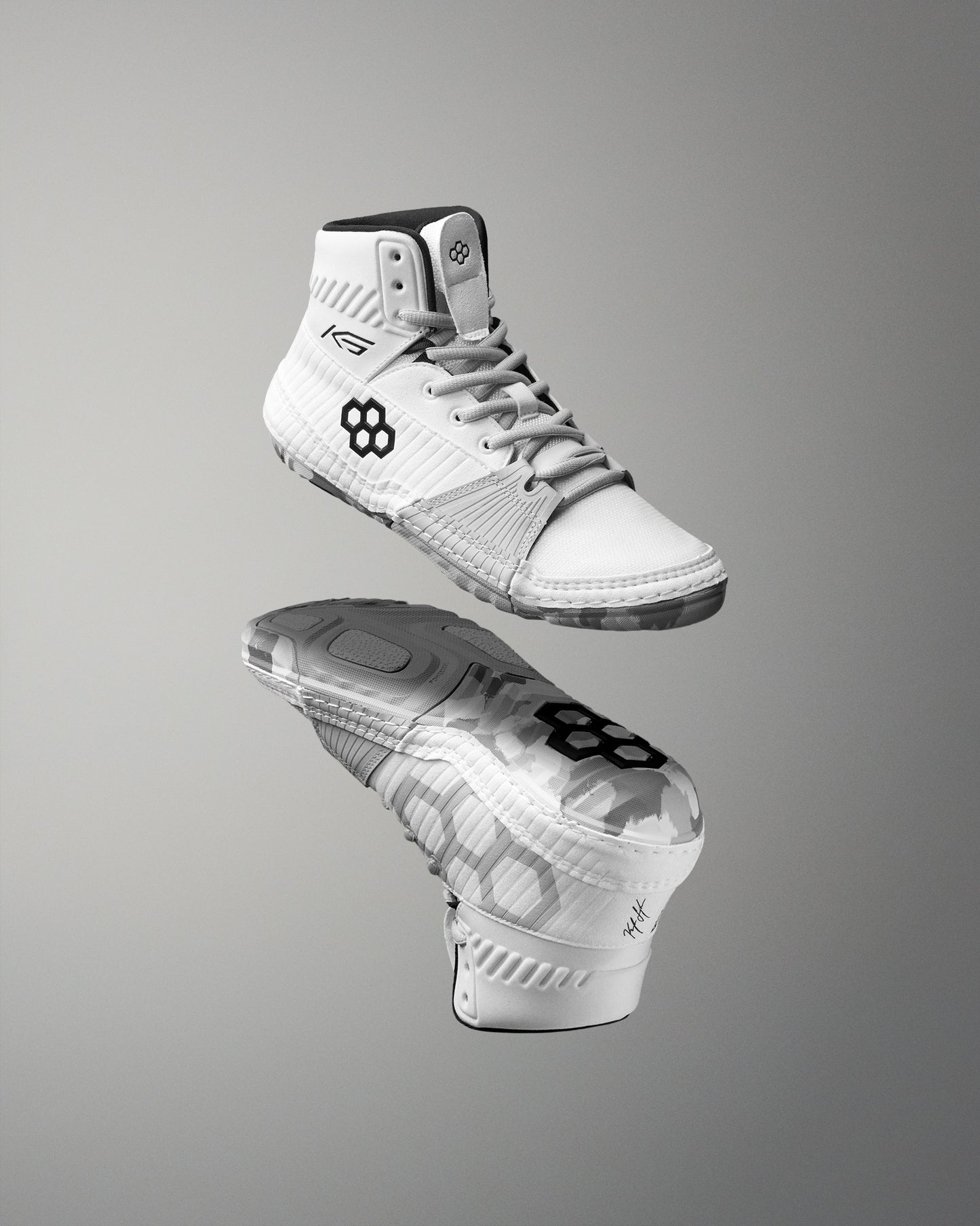 White wrestling shoes with black sole on a gray background
