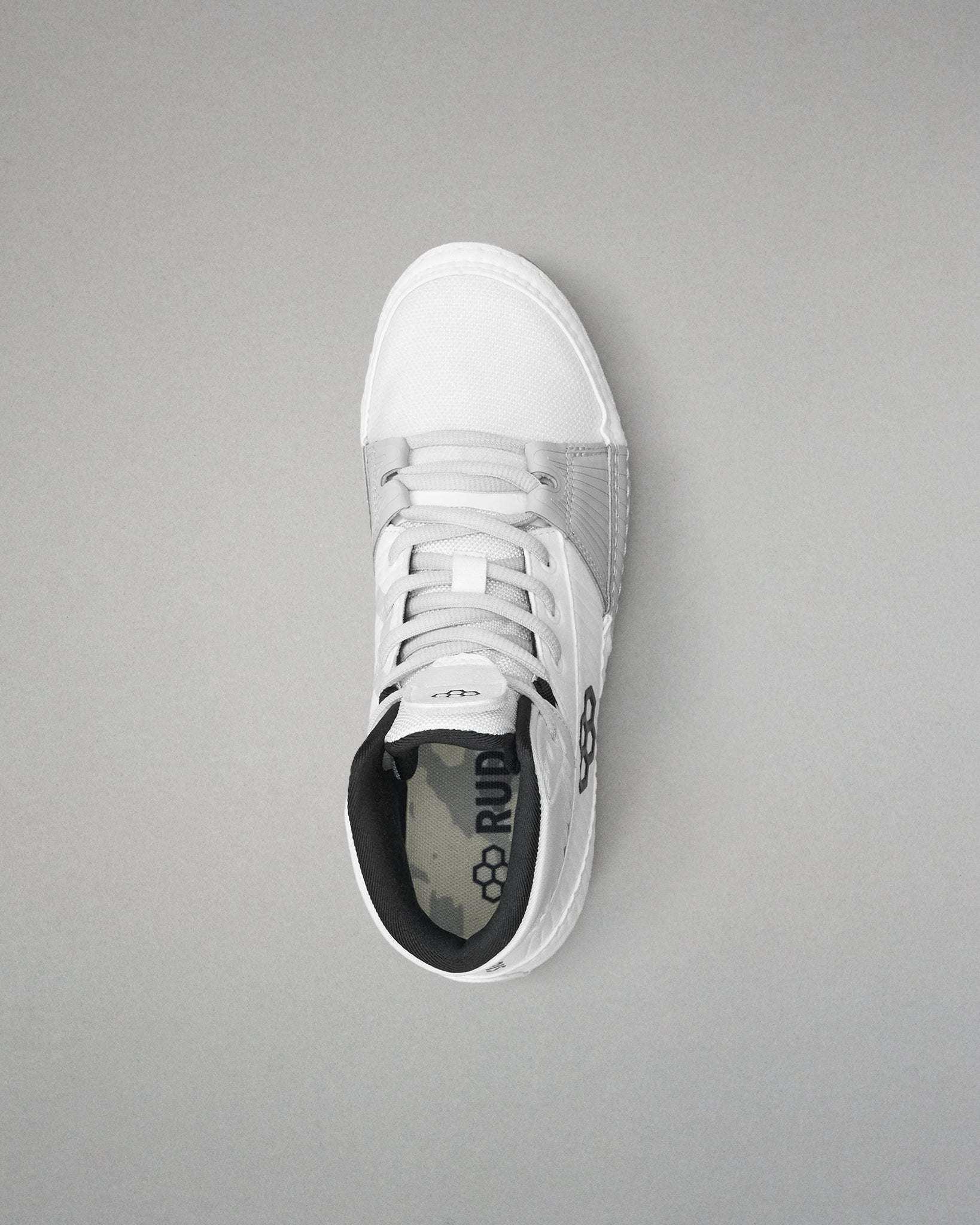 White wrestling shoe with black sole on a gray background