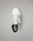 White wrestling shoe with black sole on a gray background