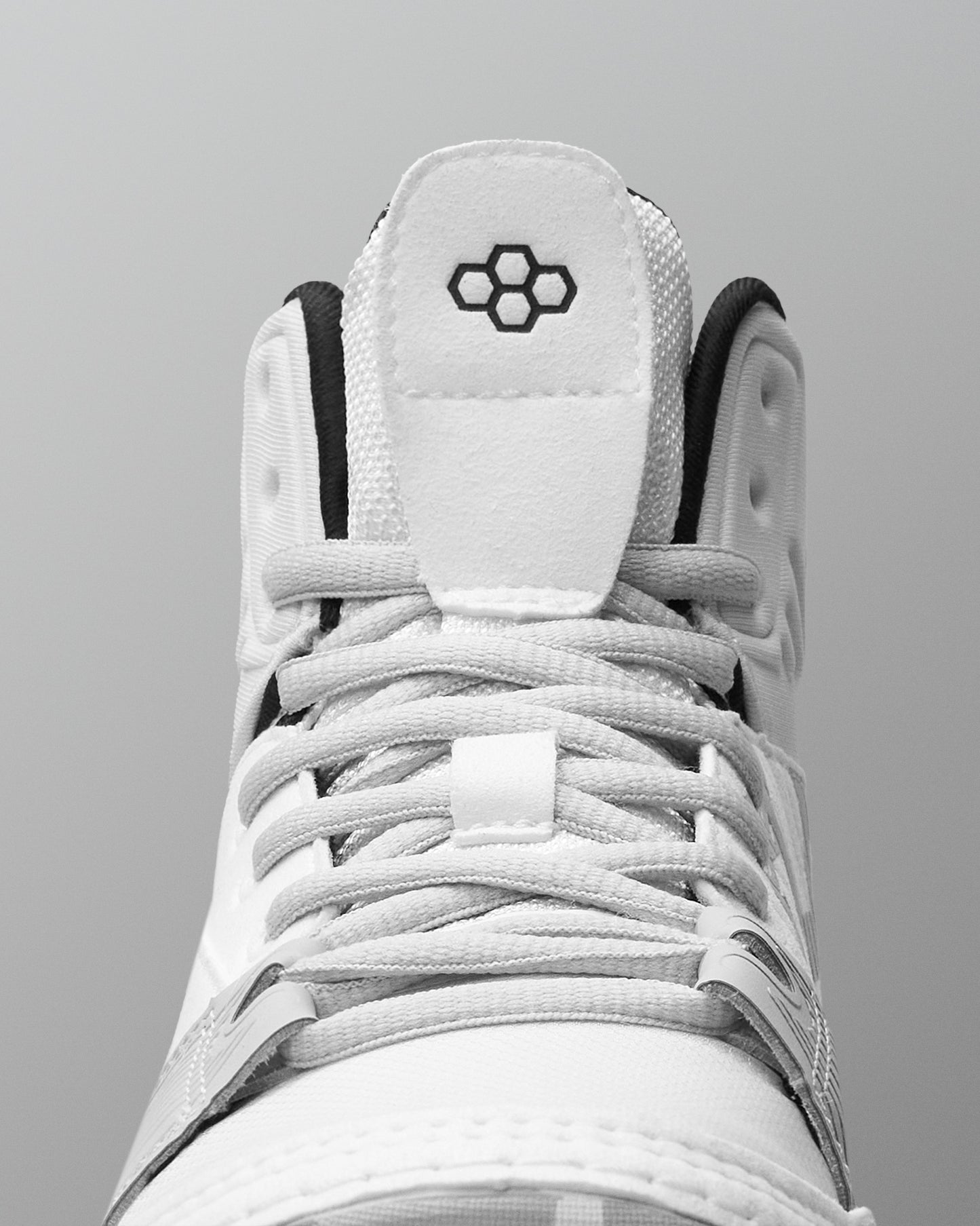 White wrestling shoe with black accents on a gray background