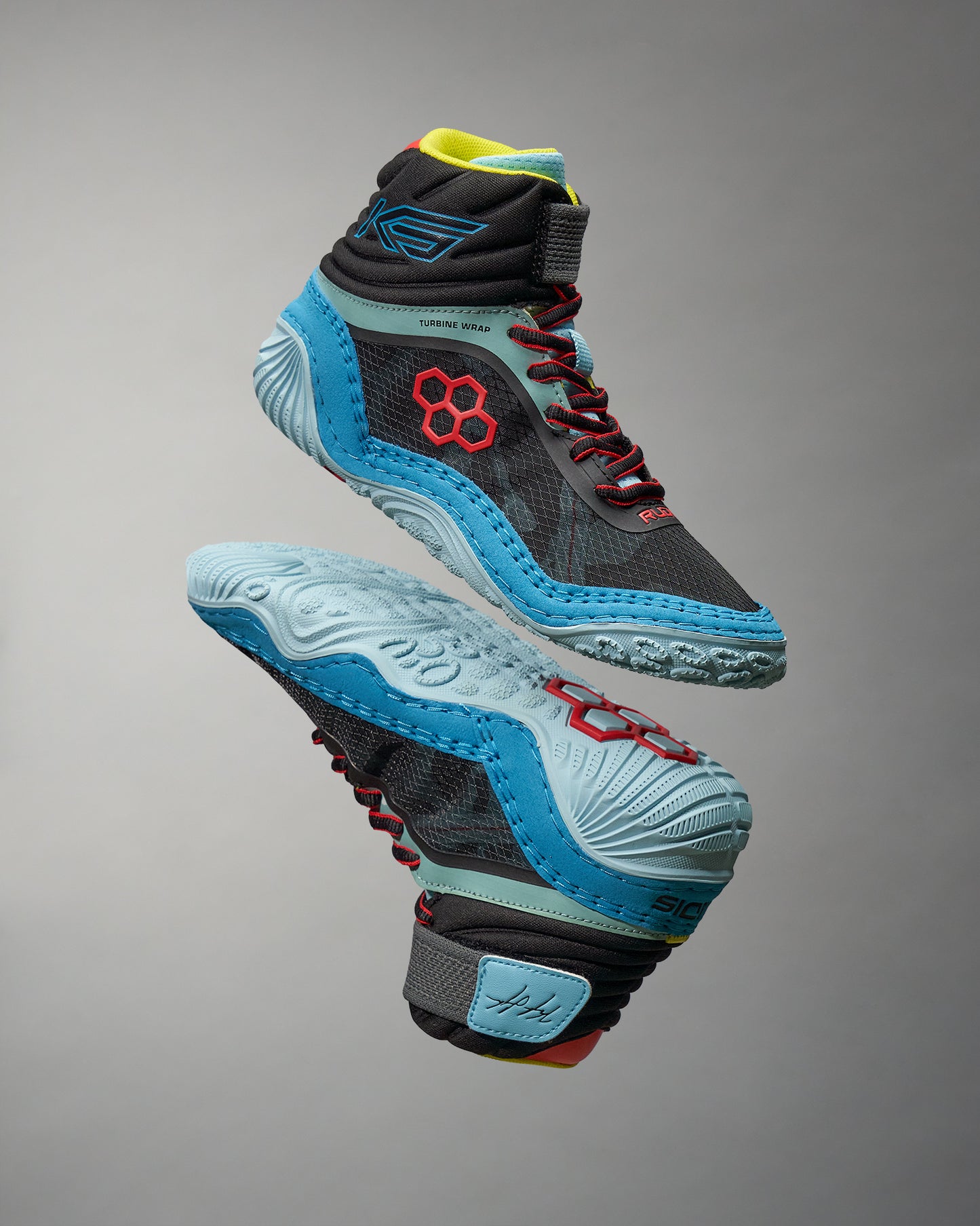 A modern pair of high-top athletic shoes featuring a black upper with vibrant blue red and yellow accents designed for performance in sports