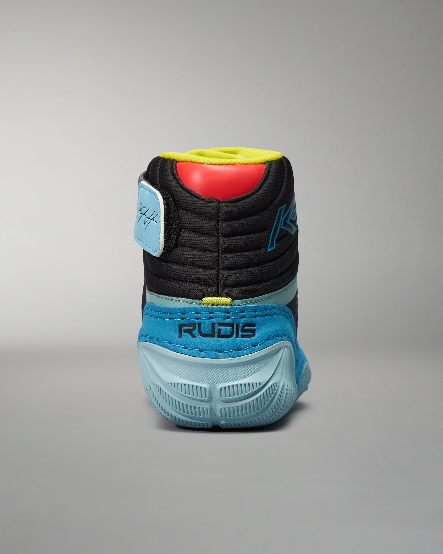 A rear view of a sleek black and blue athletic shoe featuring a textured sole and vibrant accent colors
