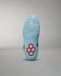 This image displays the sole of a blue athletic shoe featuring a unique red hexagonal design showcasing its textured surface for enhanced grip and performance