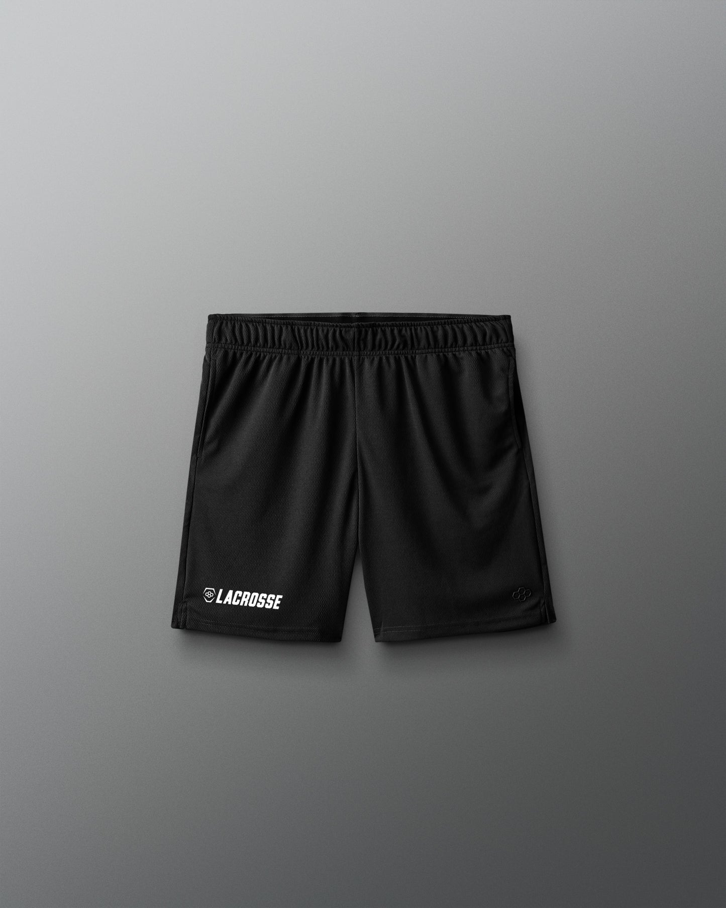 Black lacrosse shorts on a gray background