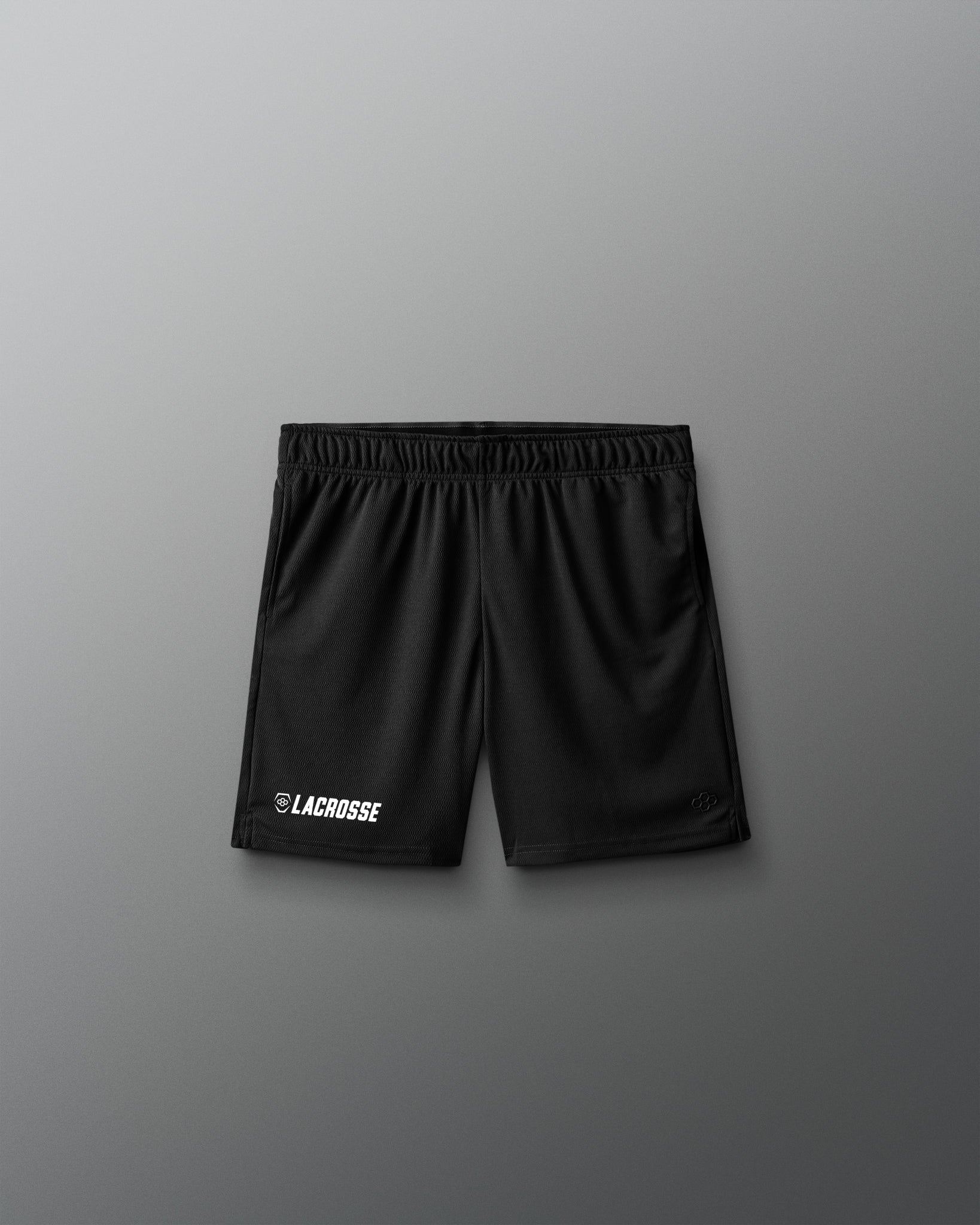 Black lacrosse shorts on a gray background