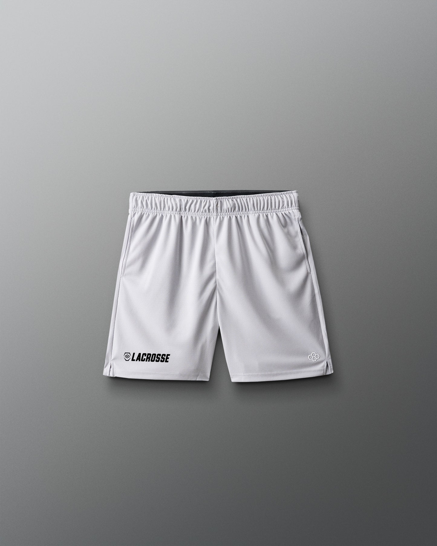 White lacrosse shorts on a gray background