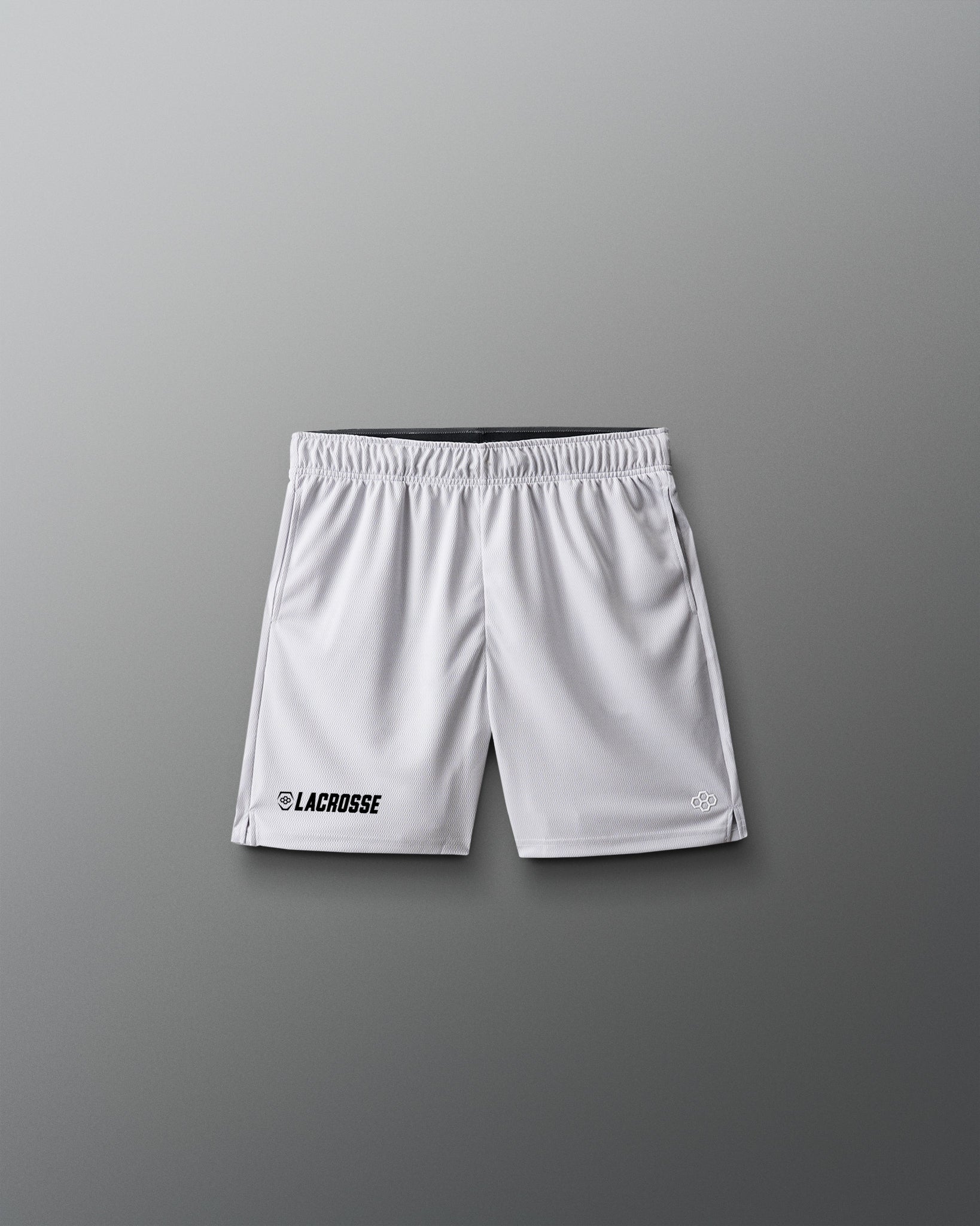 White lacrosse shorts on a gray background