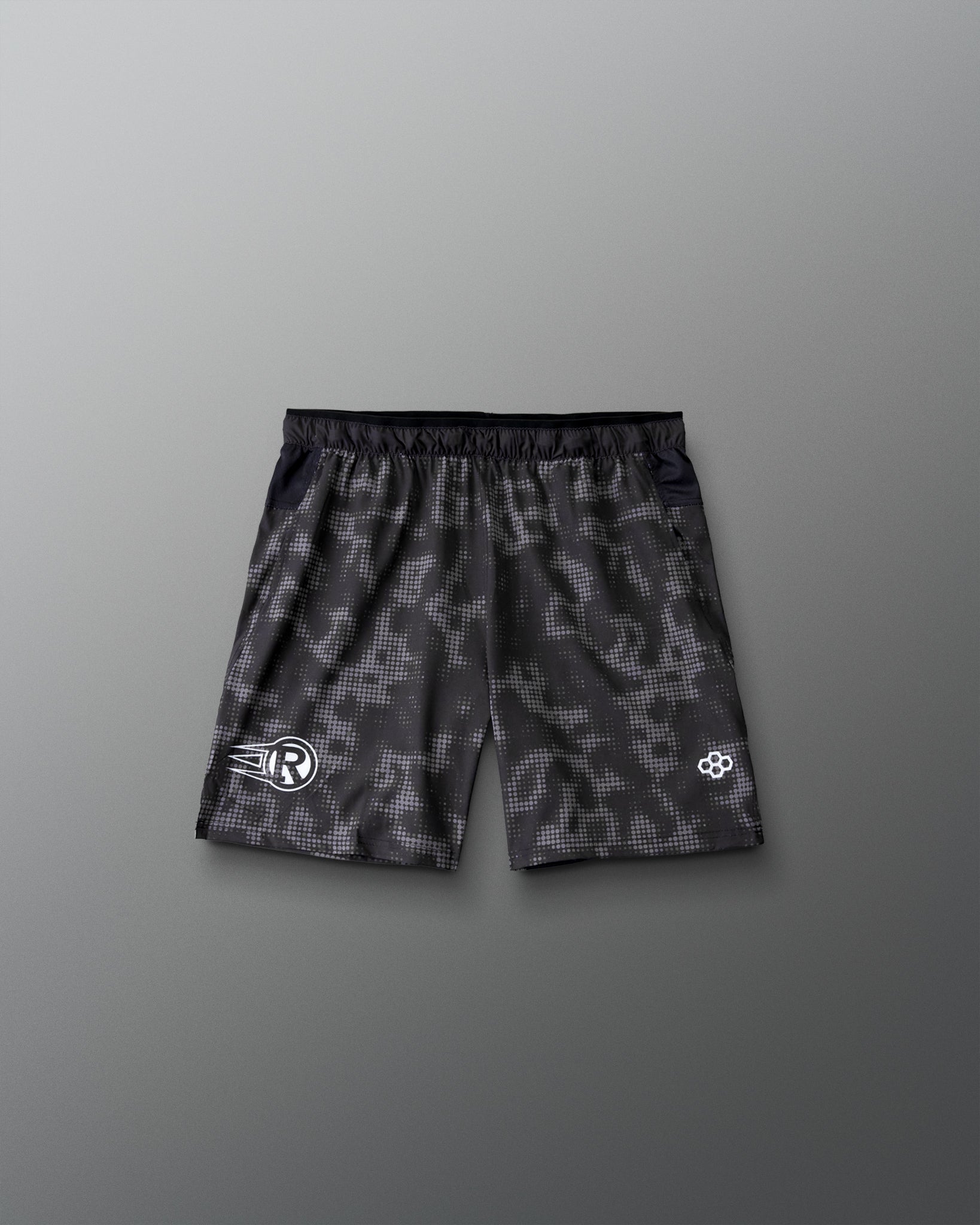 RUDIS Resolute Attack youth lacrosse shorts in black with a tonal camo print, featuring an elastic waistband, athletic fit, and clean back design.