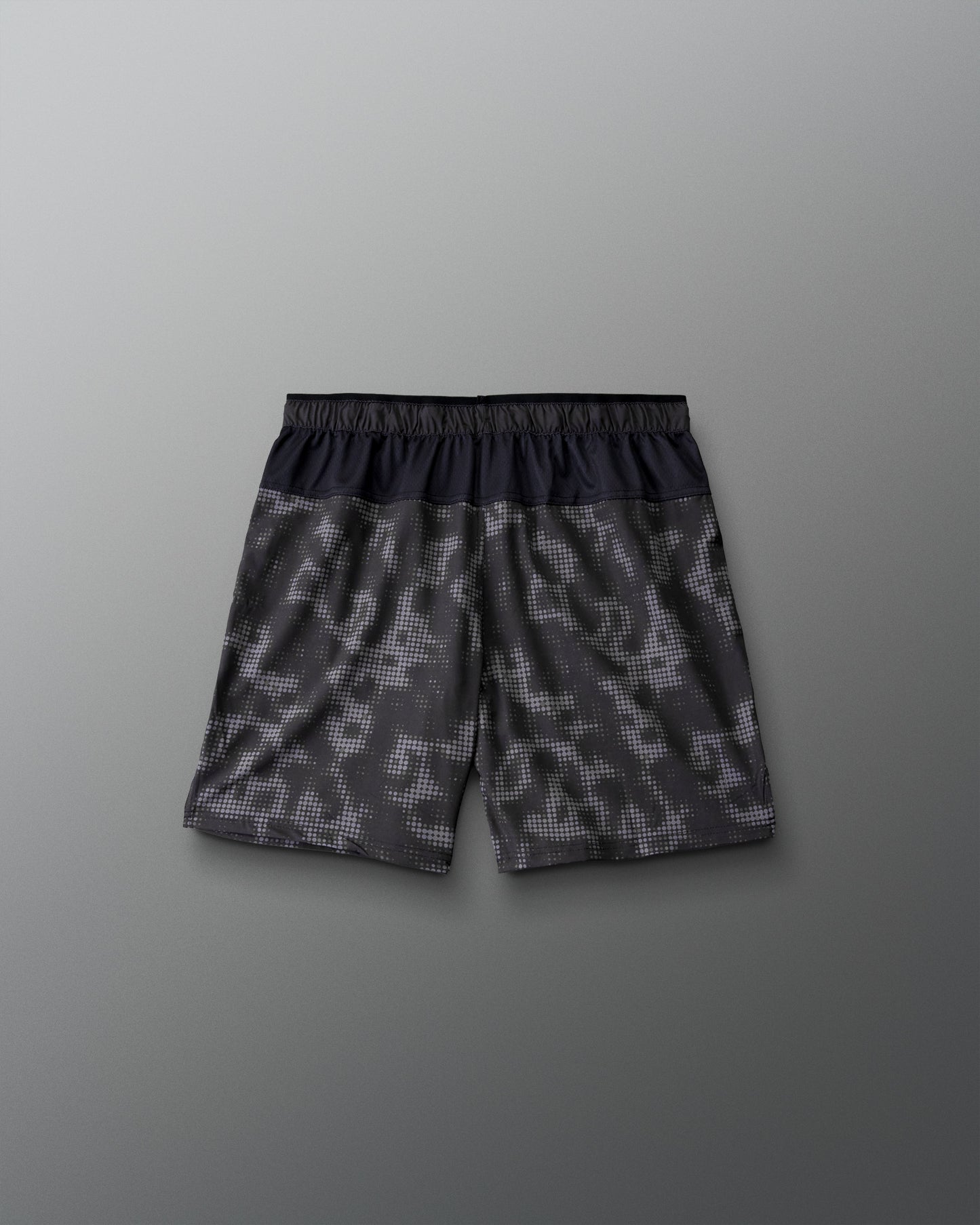 RUDIS Resolute Attack youth lacrosse shorts in black with a tonal camo print, featuring an elastic waistband, side pockets, Rocket logo on the left leg, and RUDIS logo on the right leg.
