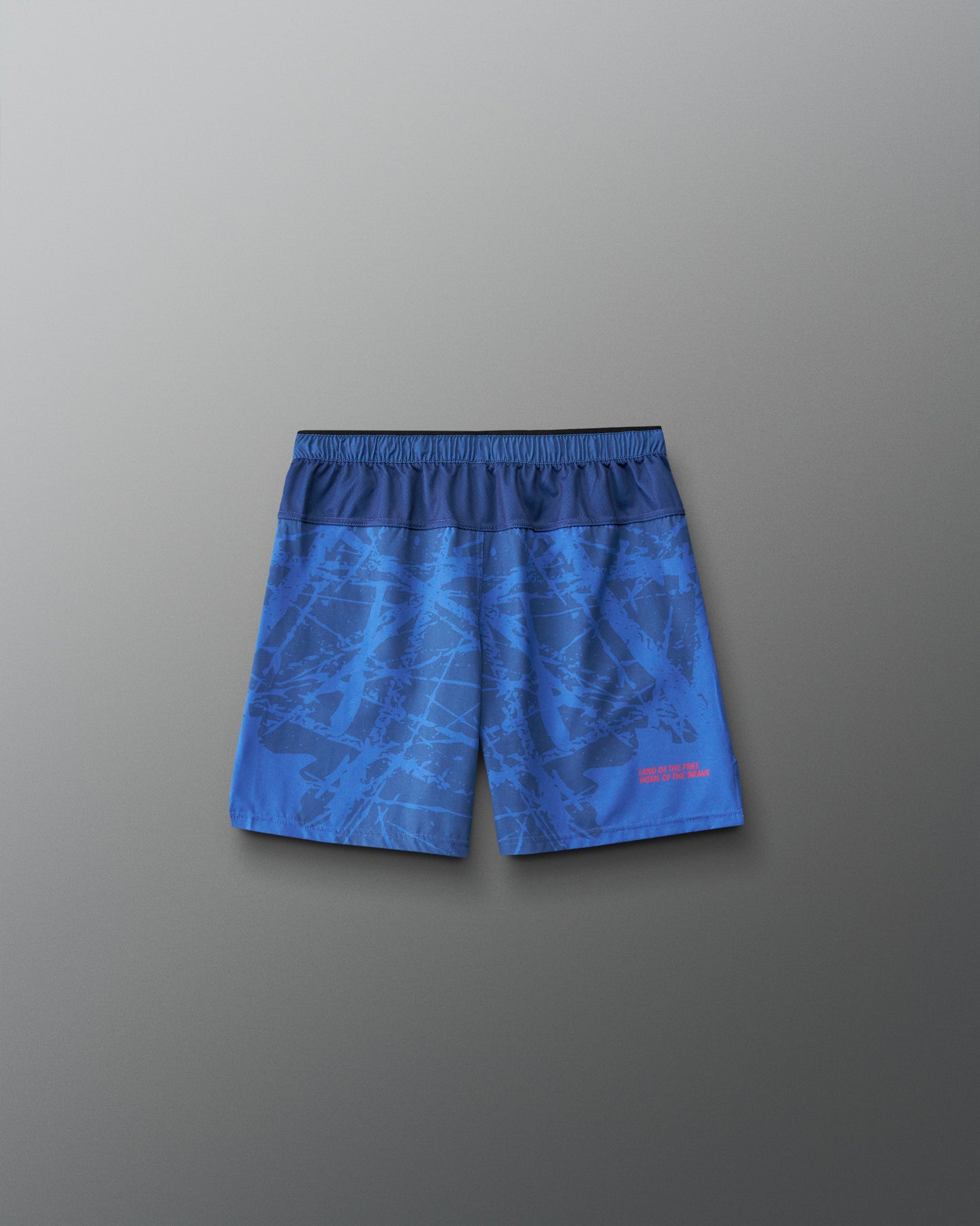 Back view of RUDIS Lacrosse Flag Boys 7" Attack Shorts in navy with tonal graphic print and “Land of the Free, Home of the Brave” detail.