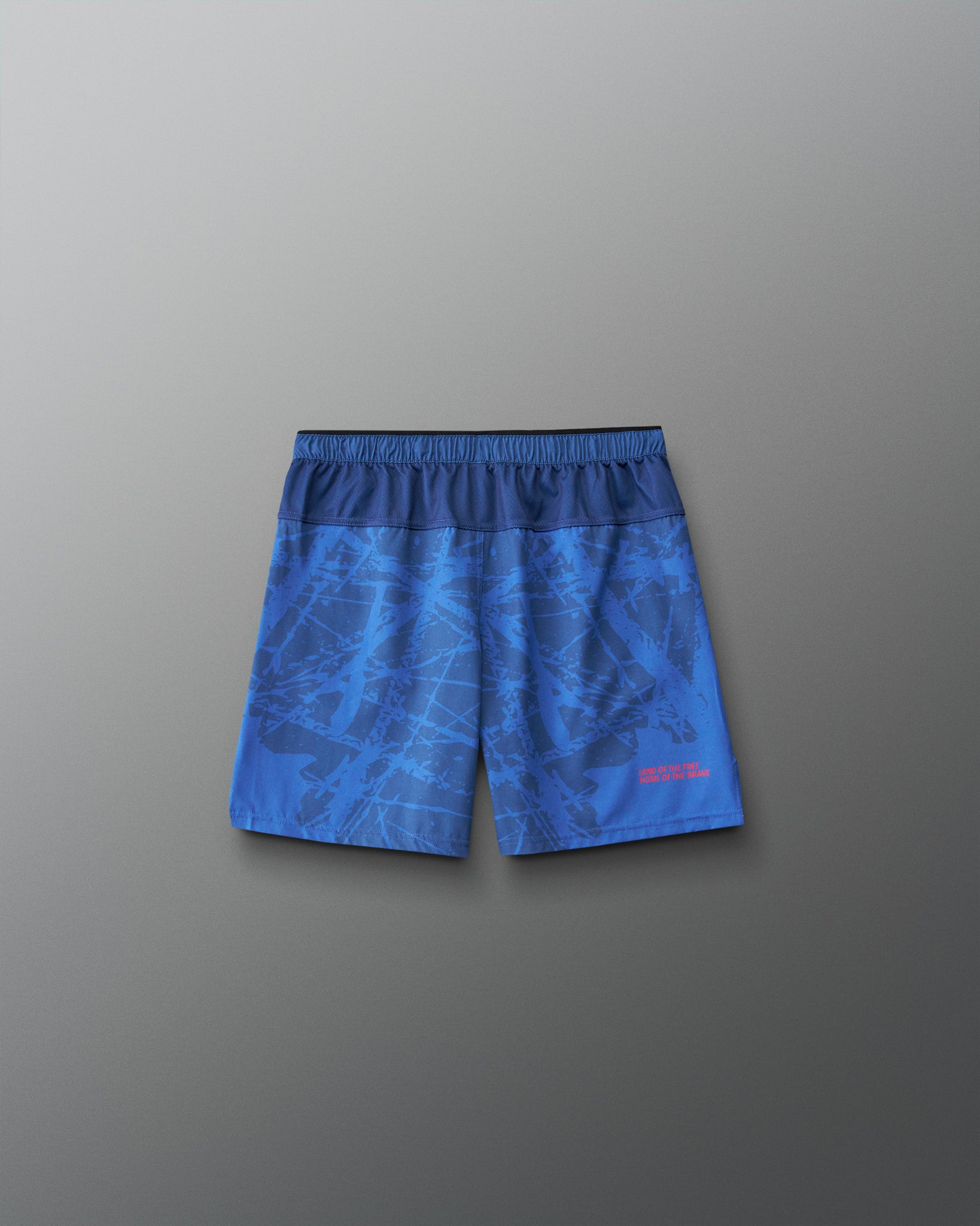 Back view of RUDIS Lacrosse Flag Boys 7" Attack Shorts in navy with tonal graphic print and “Land of the Free, Home of the Brave” detail.