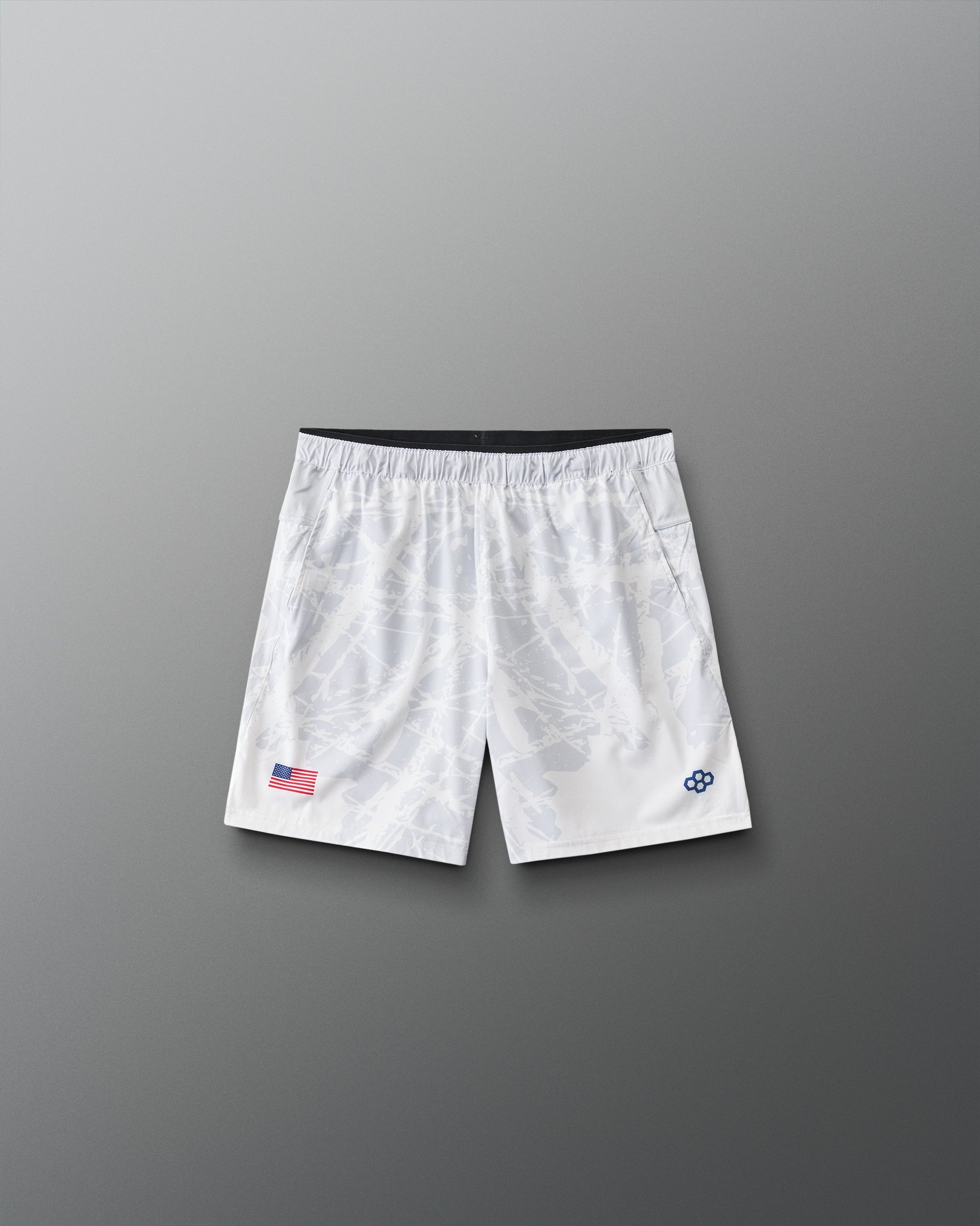 Front view of RUDIS Lacrosse Flag Boys 7" Attack Shorts in white with tonal graphic print, American flag detail, and RUDIS logo.