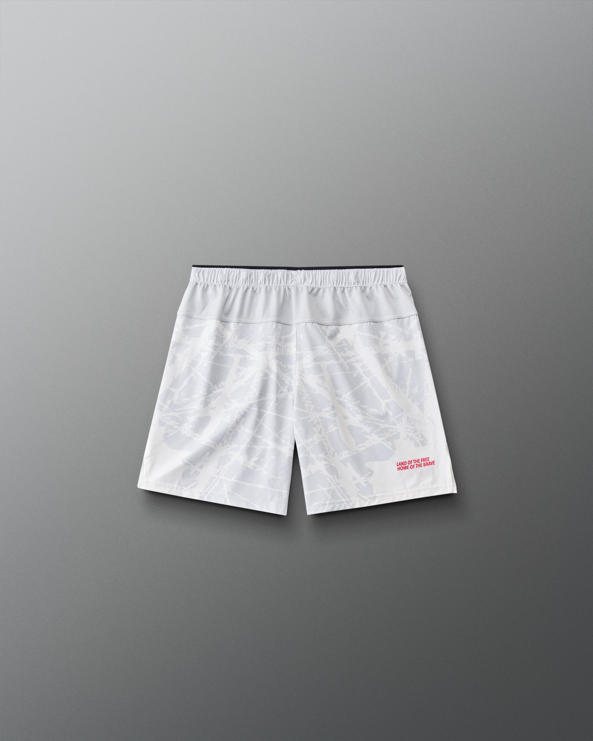Back view of RUDIS Lacrosse Flag Boys 7" Attack Shorts in white with tonal graphic print and “Land of the Free, Home of the Brave” detail.