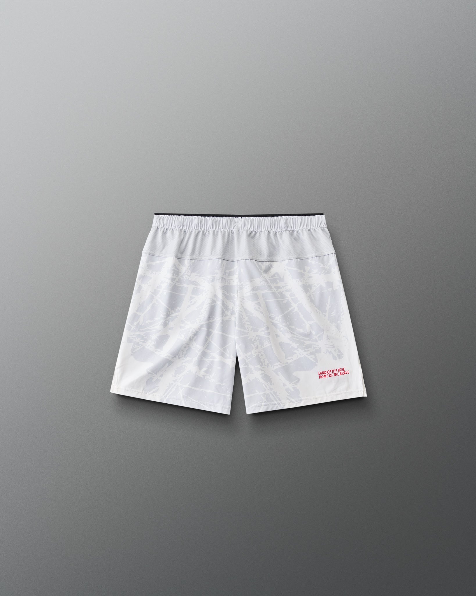 Back view of RUDIS Lacrosse Flag Boys 7" Attack Shorts in white with tonal graphic print and “Land of the Free, Home of the Brave” detail.