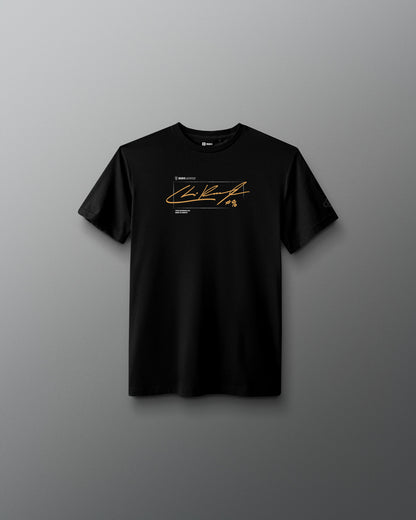 A black short-sleeve crewneck t-shirt with a gold and white graphic print on the chest, displayed against a dark gray gradient background.