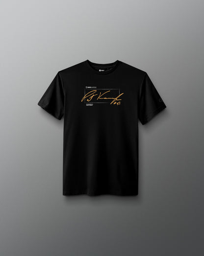 A black short-sleeve crewneck t-shirt with a gold and white graphic print on the chest, displayed against a dark gray gradient background.