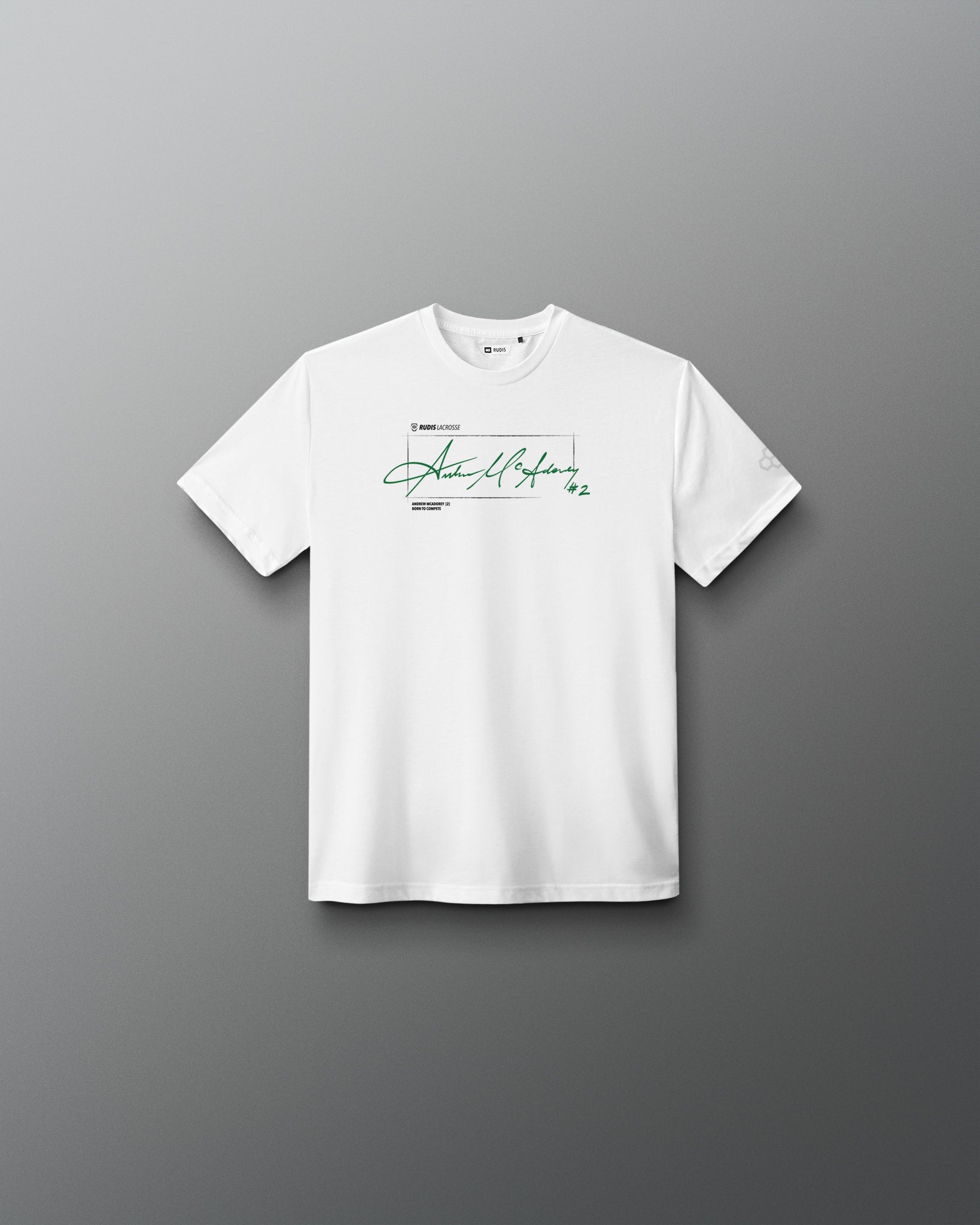 White RUDIS Youth Elite Super Soft T-Shirt featuring Andrew McAdorey's signature in green across the chest with RUDIS Lacrosse branding and #2 graphic.