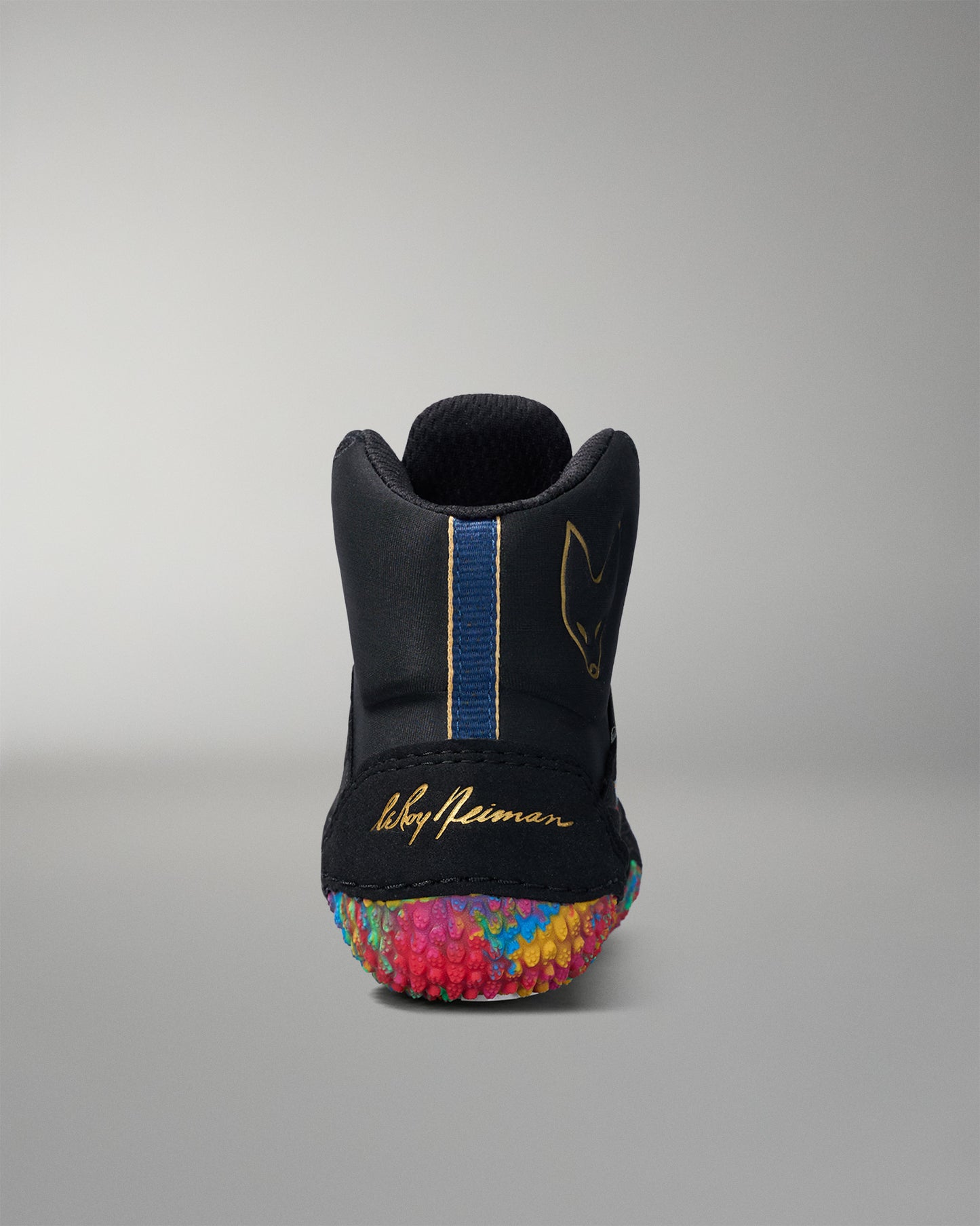 Black wrestling shoe with colorful sole on a gray background