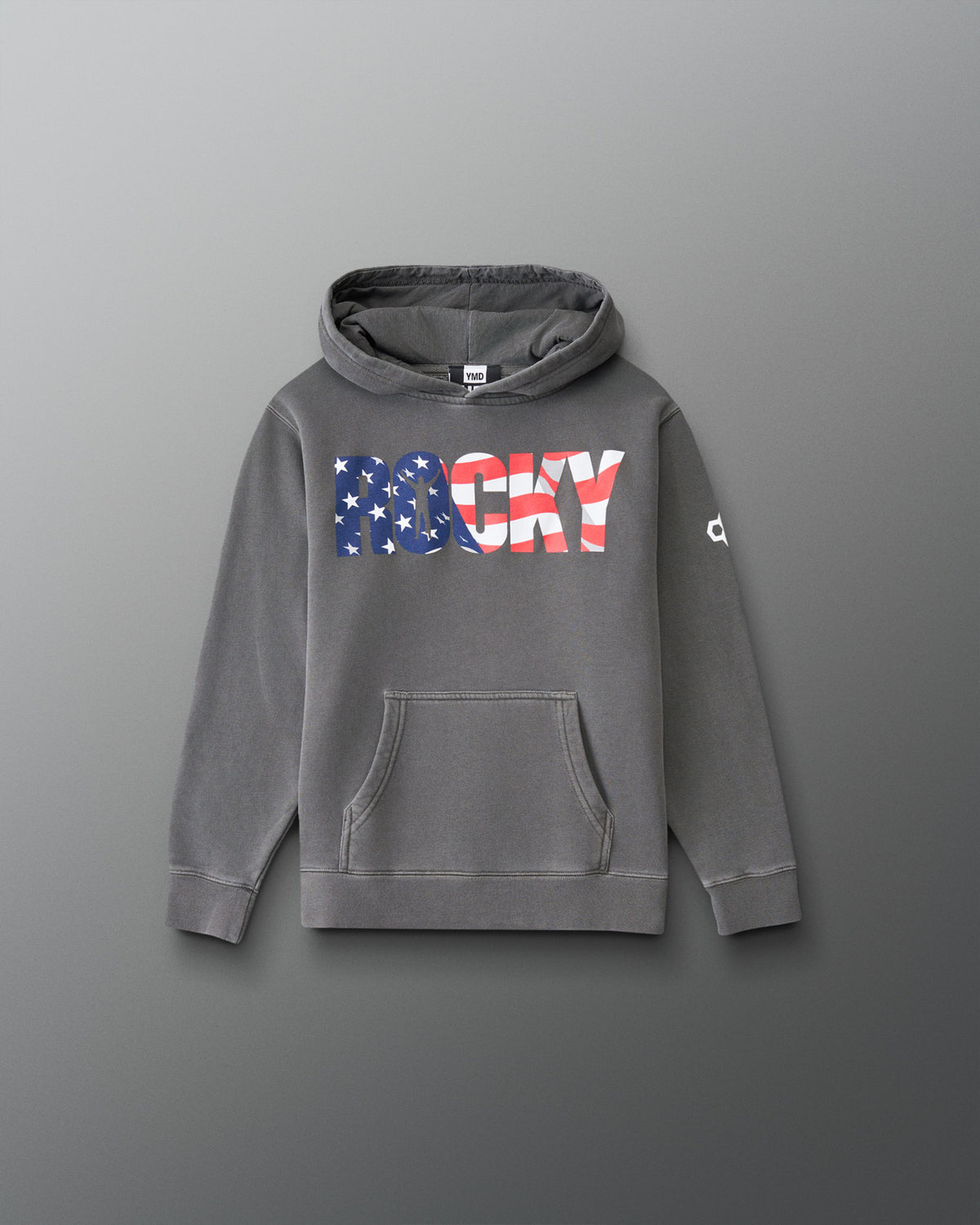 A gray pullover hoodie with a front kangaroo pocket and a large 'ROCKY' graphic across the chest in an American flag pattern. The word 'ROCKY' is filled with blue and white stars on the left side and red and white stripes on the right side.