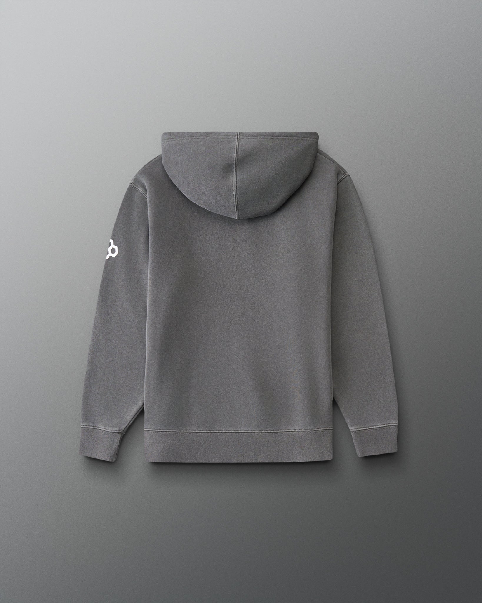 A gray hooded sweatshirt shown from the back, featuring a small white logo on the left sleeve, set against a dark gray gradient background.