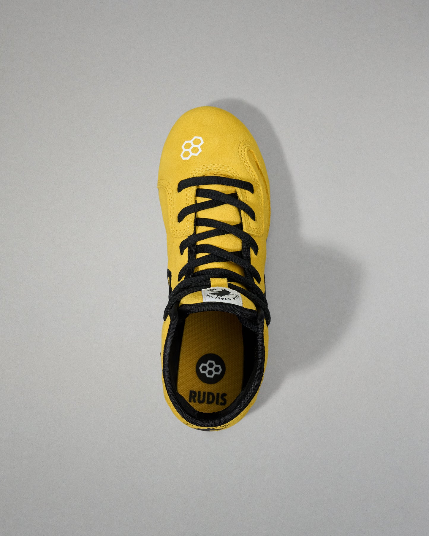 Top view - Yellow wrestling shoe with black laces on a gray background