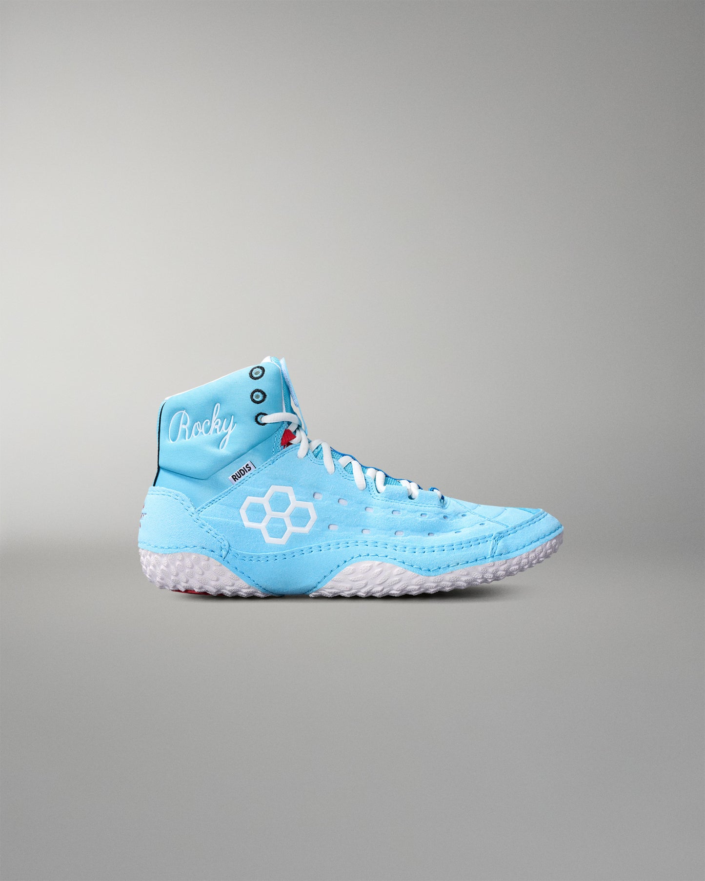 Light blue wrestling shoe with white sole on a gray background