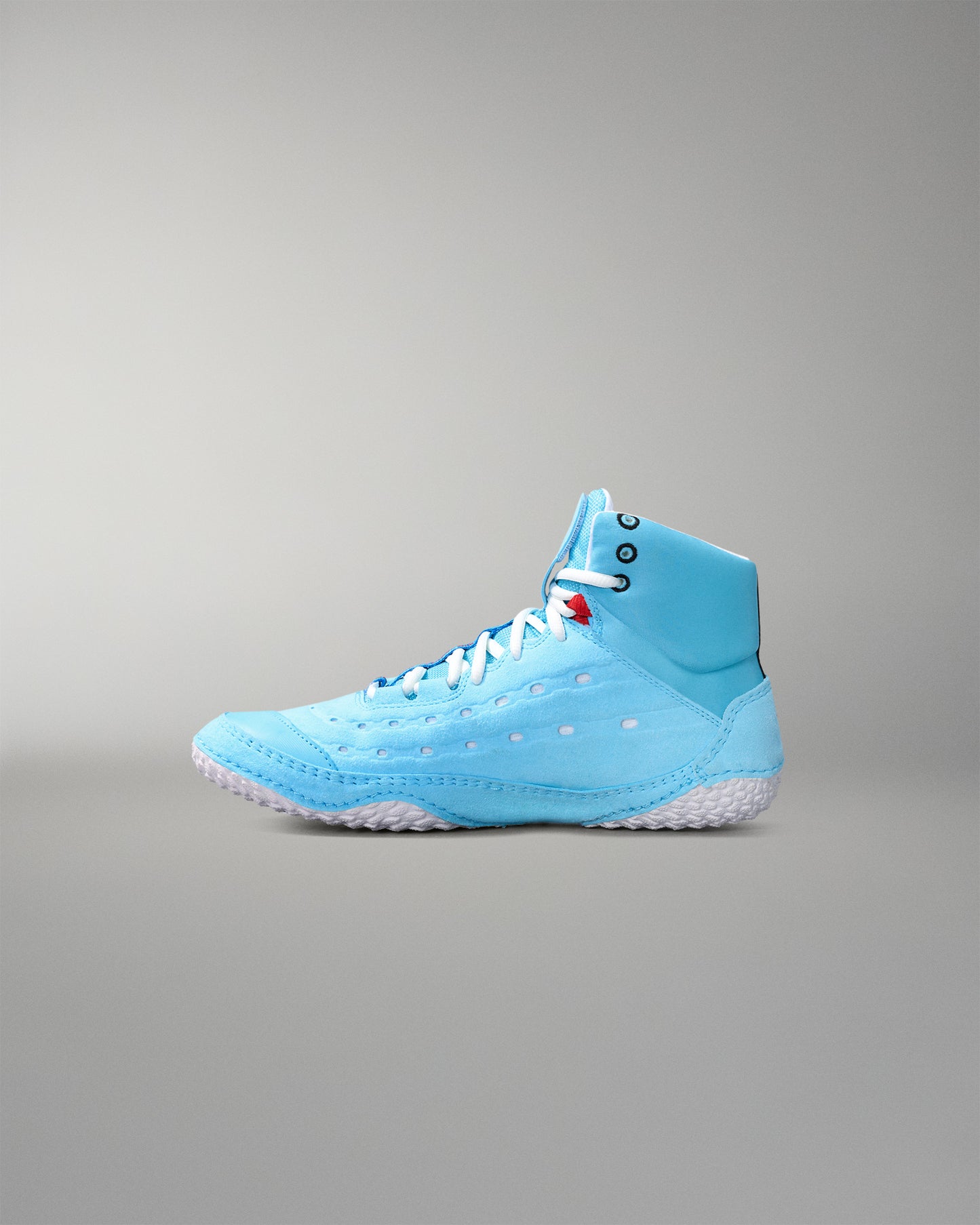 Light blue wrestling shoe with white sole on a gray background
