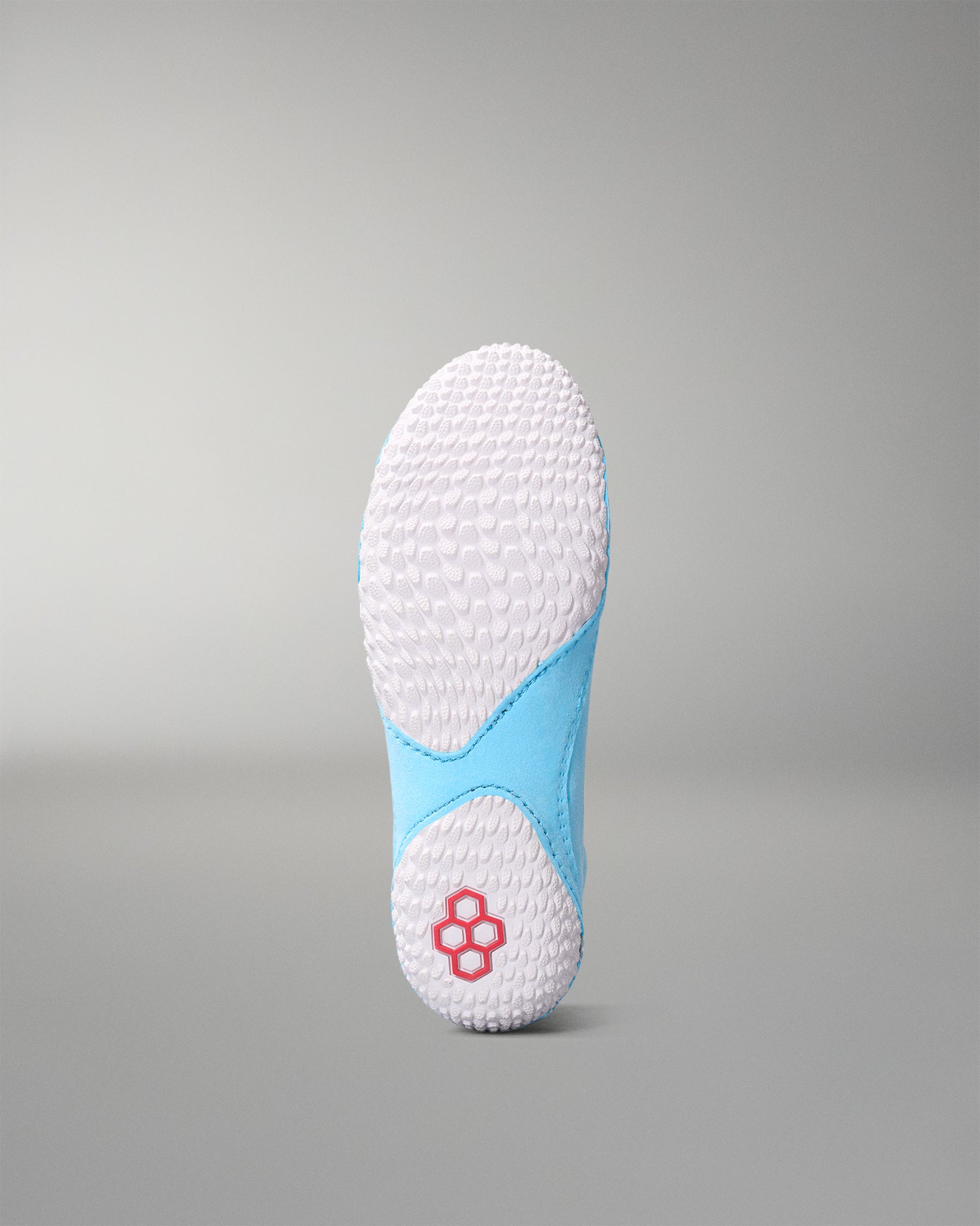 White and blue insole with textured sole on a gray background